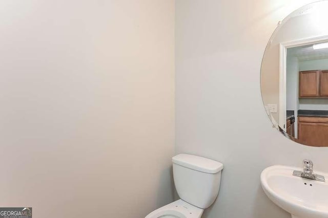 bathroom featuring sink and toilet