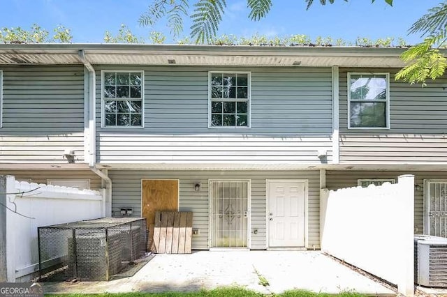 view of front of property featuring a patio area and central air condition unit