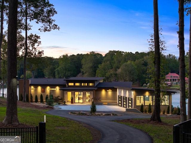 view of back house at dusk