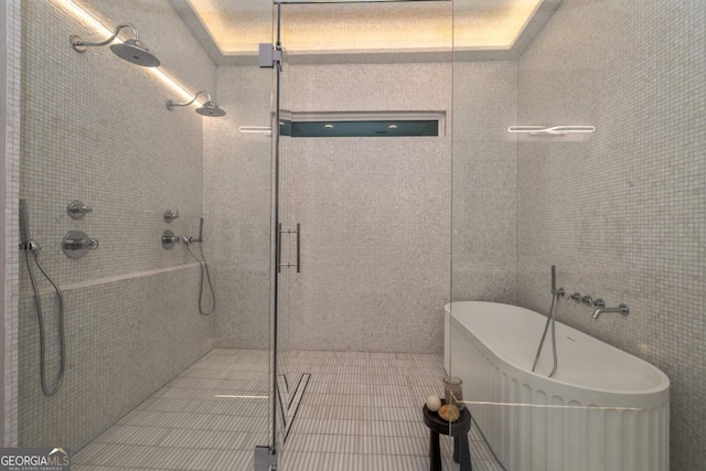 bathroom with tile patterned flooring and independent shower and bath