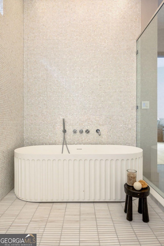 bathroom with radiator heating unit, a bathing tub, and tile walls