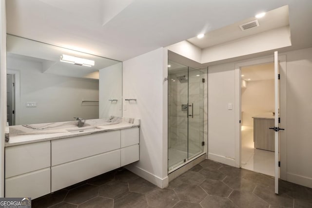 bathroom with vanity, an enclosed shower, and tile patterned flooring