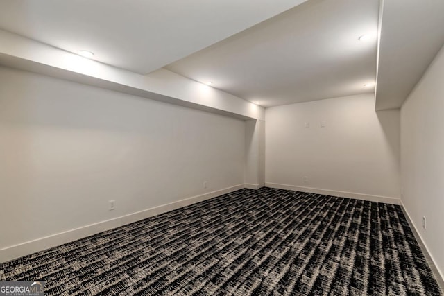 basement featuring dark carpet