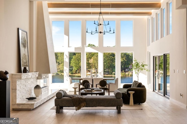 interior space with a water view, a chandelier, and a wealth of natural light