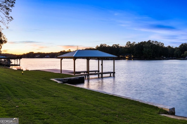 dock area featuring a water view and a yard