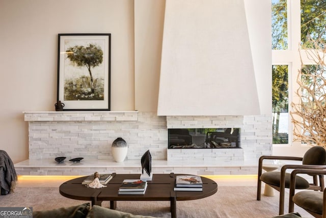 living room featuring a brick fireplace