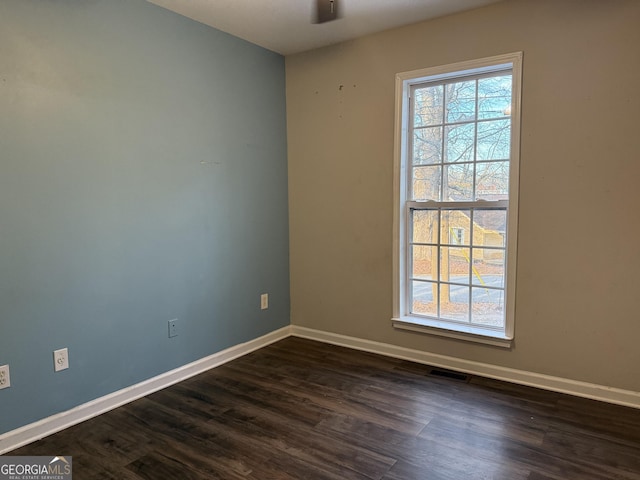 unfurnished room featuring dark hardwood / wood-style flooring