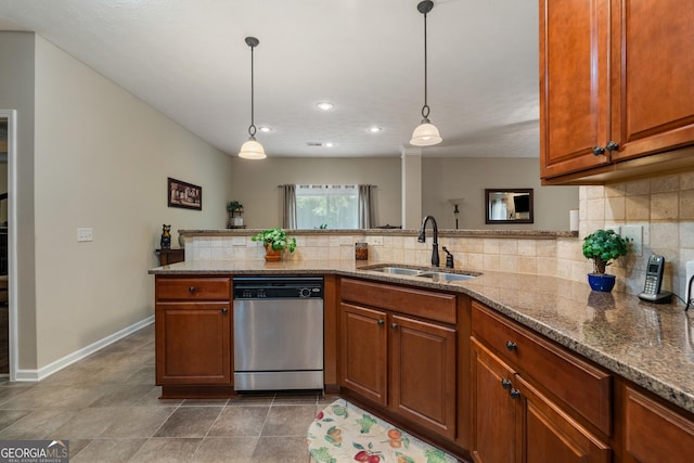 kitchen with decorative light fixtures, dishwasher, sink, and light stone countertops