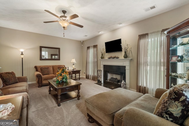 carpeted living room featuring ceiling fan