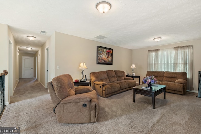 living room with light carpet and a textured ceiling