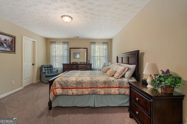 carpeted bedroom with a textured ceiling