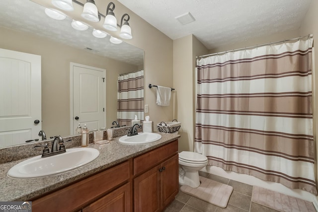 bathroom featuring vanity, tile patterned floors, a textured ceiling, and a shower with shower curtain