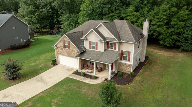 craftsman-style home featuring a garage, a porch, and a front yard