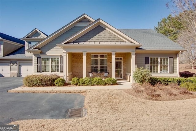 view of front of home with a garage and a porch