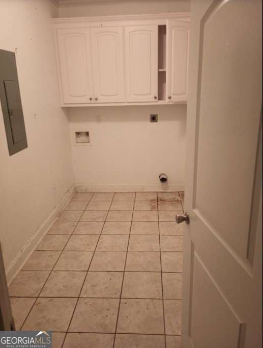 laundry area with light tile patterned floors, electric panel, cabinets, washer hookup, and hookup for an electric dryer