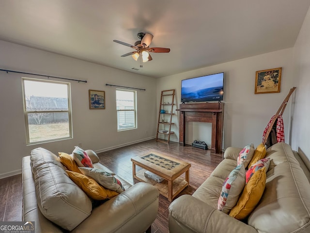 living room featuring ceiling fan and dark hardwood / wood-style flooring