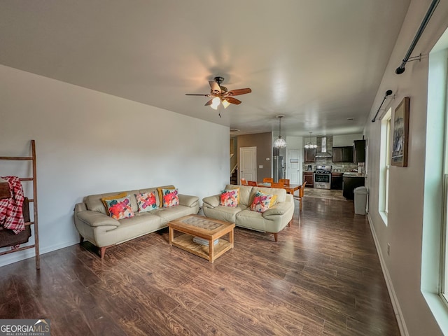 living room with dark hardwood / wood-style floors and ceiling fan