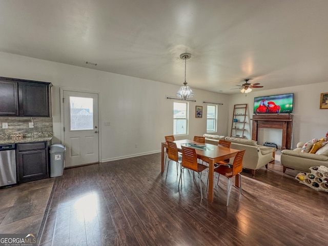 dining space with dark hardwood / wood-style floors and ceiling fan