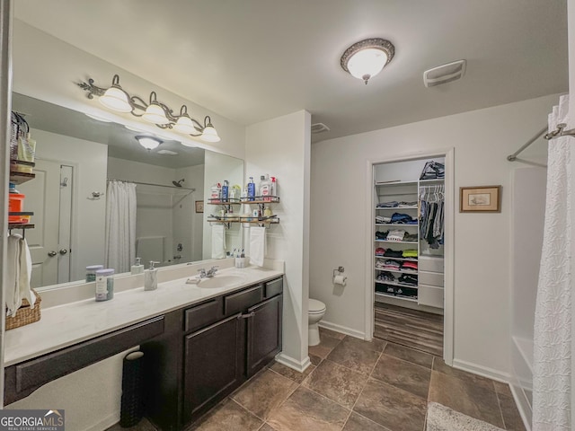 bathroom with vanity, curtained shower, and toilet