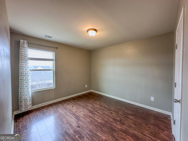 spare room with dark wood-type flooring