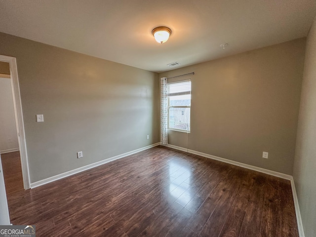 empty room with dark wood-type flooring