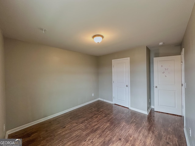 unfurnished bedroom with dark hardwood / wood-style floors