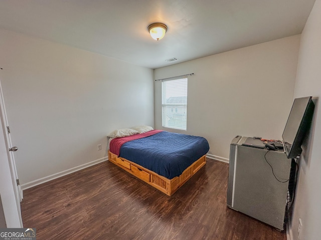 bedroom with dark hardwood / wood-style flooring