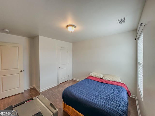 bedroom featuring dark hardwood / wood-style flooring