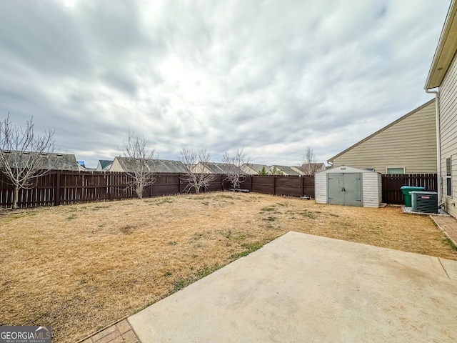 view of yard featuring a patio, central air condition unit, and a storage shed