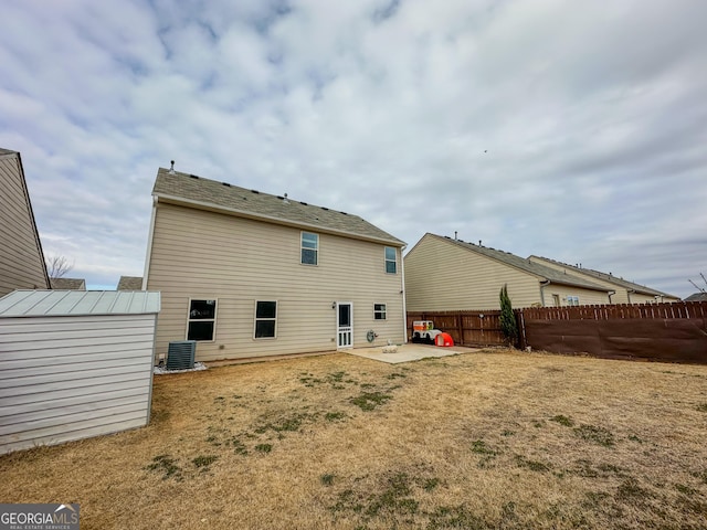 rear view of property with a patio, a yard, a shed, and central air condition unit