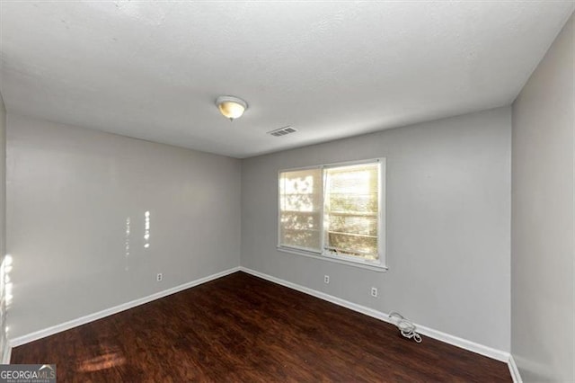 unfurnished room featuring hardwood / wood-style flooring