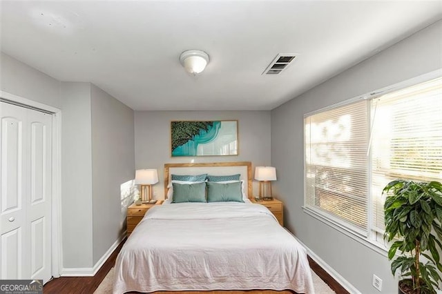 bedroom with wood-type flooring and a closet