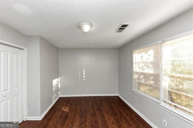 unfurnished room featuring dark hardwood / wood-style floors