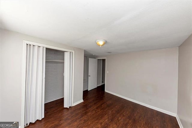 unfurnished bedroom featuring dark hardwood / wood-style flooring