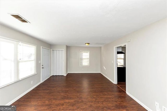 empty room featuring dark wood-type flooring