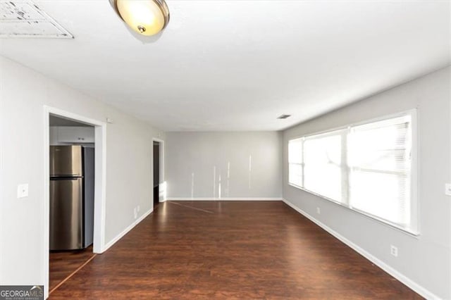 unfurnished living room with dark hardwood / wood-style flooring