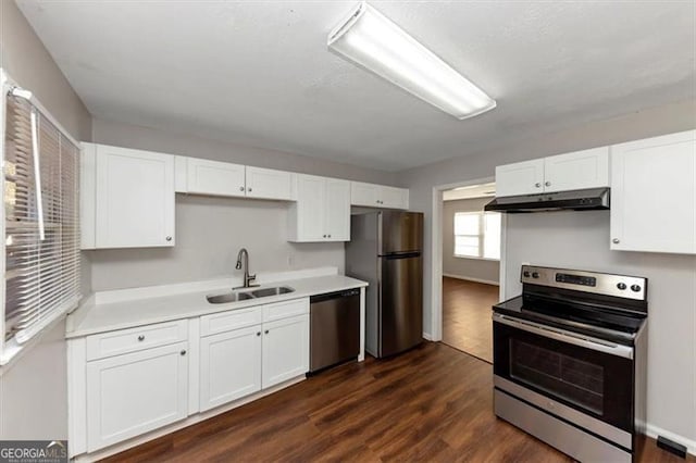 kitchen with dark hardwood / wood-style flooring, sink, white cabinets, and appliances with stainless steel finishes