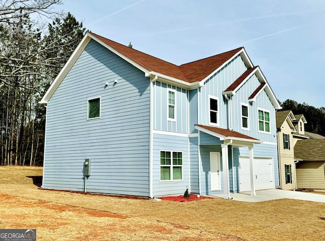 view of front of home with a garage and a front yard