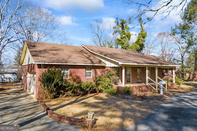 view of front of house with a porch and a garage