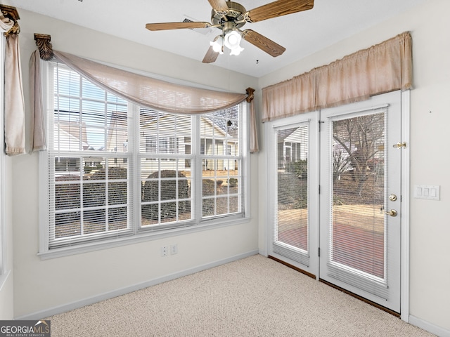 interior space with ceiling fan and carpet flooring