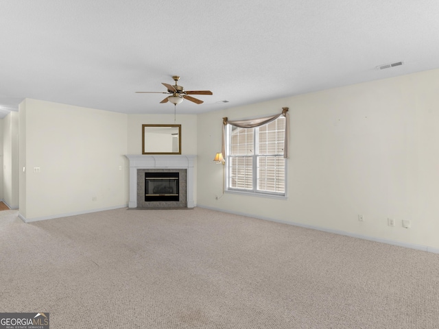 unfurnished living room with light carpet and ceiling fan