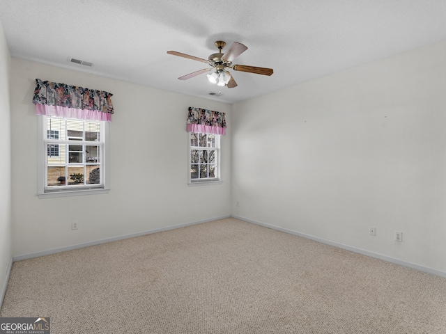 carpeted empty room with ceiling fan