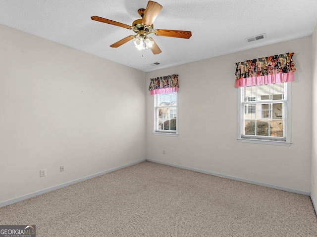 unfurnished room with carpet and ceiling fan