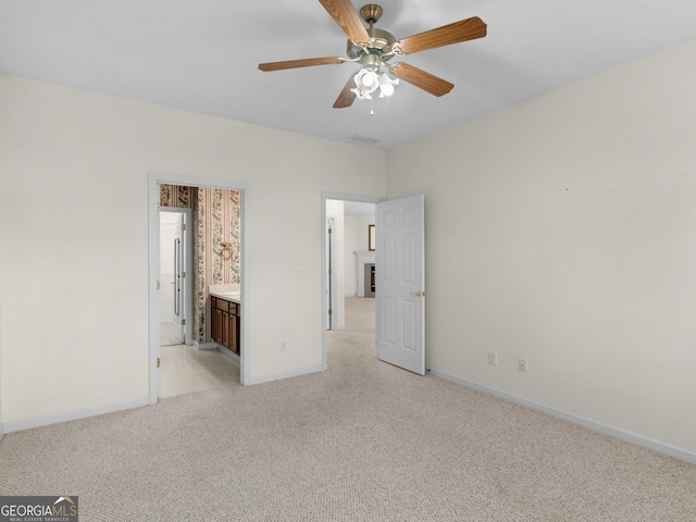 unfurnished bedroom with ceiling fan, connected bathroom, and light carpet