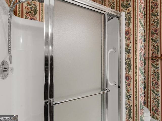 bathroom with an enclosed shower and toilet