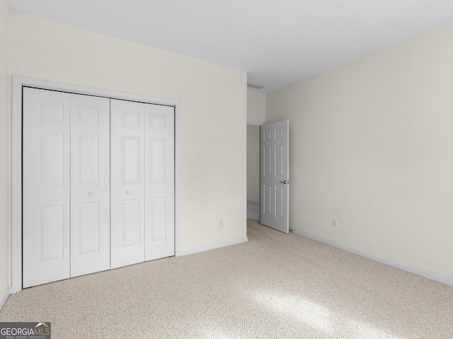 unfurnished bedroom with a closet and carpet