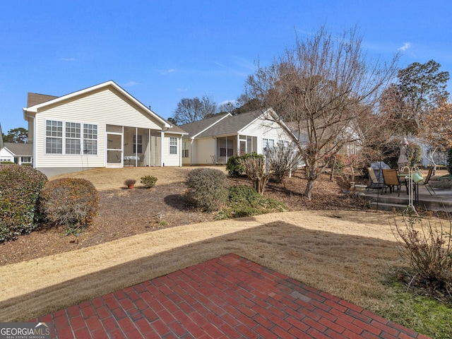 back of house with a patio area and a sunroom