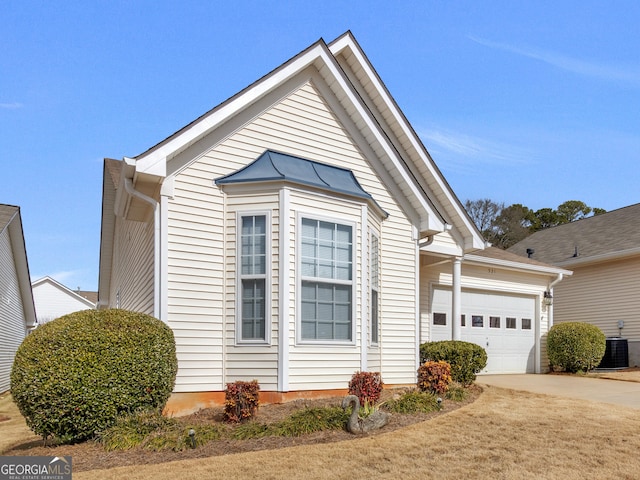 view of front facade featuring a garage and central AC