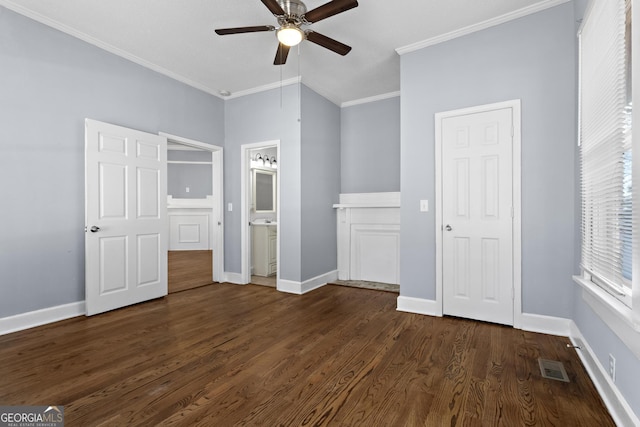 unfurnished bedroom featuring ensuite bath, ornamental molding, dark hardwood / wood-style floors, and ceiling fan