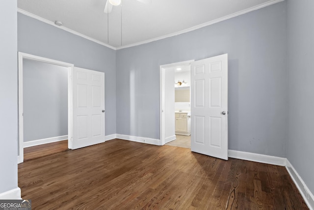 unfurnished bedroom featuring crown molding, ceiling fan, connected bathroom, and dark hardwood / wood-style flooring